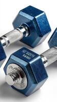 Two blue hexagonal dumbbells resting on a light surface showcasing their unique design and details suitable for workouts or home gym setups photo