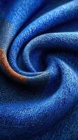 Textured blue fabric displays intricate weaving patterns and a soft, inviting feel in a close-up view capturing fine details photo