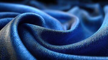 Beautiful deep blue fabric with rich texture and gentle folds showcasing elegance and luxury in soft lighting photo
