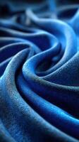 Textured blue fabric creates a wave-like pattern with intricate folds and shadows, perfect for upholstery or fashion design inspiration photo