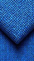 Textured blue fabric showing intricate weaving pattern, ideal for home decor and fashion projects photo