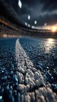 Racing tracks in an empty stadium during twilight with bright lights illuminating the scene photo