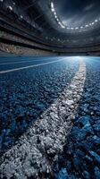 Stunning view of an empty stadium with focus on the blue track and white lane line during twilight hours photo