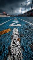 Track surface with lane markings under an overcast sky during an athletic event at a sports facility photo