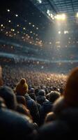 Crowd gathers in a stadium during an evening event with bright lights and a colorful atmosphere photo