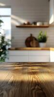 Wooden kitchen countertop reflecting warm sunlight with blurred background of modern kitchen design and plants photo