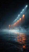 Misty night on an empty street illuminated by glowing streetlights reflecting on wet pavement photo