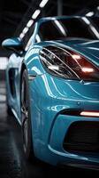 Sporty blue car showcasing sleek design and modern engineering in a dimly lit automotive garage setting photo