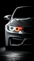 Sleek white sports car with striking headlights illuminated in a dark setting photo