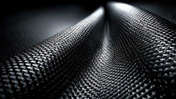Textured black fabric displays intricate patterns and depth under soft lighting, showcasing craftsmanship and design photo