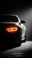 Luxury sports car in dramatic lighting showcasing sleek design features and glowing headlights in an artistic setting photo