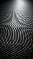 Textured surface of woven material reflecting light in a dimly lit environment at a close range photo