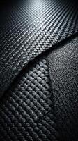 Close-up view of textured black material highlighting the intricate patterns and layers of woven fabric in a studio setting photo