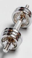 Weightlifting equipment lies on a smooth surface ready for strength training exercises photo