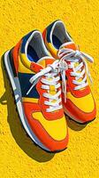 Brightly colored sneakers placed on a vibrant yellow background highlight modern footwear design and style trends photo