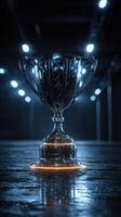 Trophy glimmering under bright lights in a dark hall, showcasing victory and achievement in competition photo