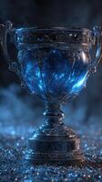 Sparkling trophy illuminated in blue light sitting on textured surface with mist photo