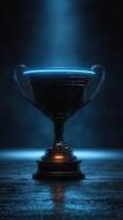 Illuminated trophy stands proudly on a dark surface, highlighting its intricate design and shiny contours during a dramatic presentation photo