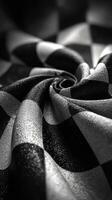 Textured black and white fabric twisted in a spiral shape highlighting geometric patterns and intricate details photo