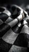 Rich texture of black and white checkered fabric draped in soft folds creating a stylish and elegant background photo