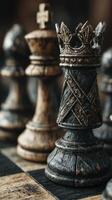 Intricate black and gold chess pieces arranged on a wooden chessboard with a focus on a royal crown piece photo