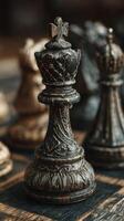 Detailed view of a carved chess king piece during a game on a wooden board photo