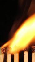 Close-up flames creating mesmerizing golden wave patterns against dark background video