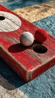 Wooden board game with colorful balls set on a sunlit surface in a relaxed outdoor setting photo