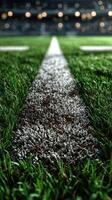 Grass field with yard markers ready for a night football game under stadium lights photo