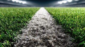 Green football field with vibrant grass and a white marking for the upcoming match in an illuminated stadium photo