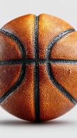 Basketball resting on a clean surface showcasing its textured design and vibrant color in bright lighting photo