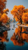 Vibrant autumn colors reflecting in calm river waters at a scenic nature location photo