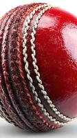 Close view of a red cricket ball showcasing its intricate stitching and texture with focus on details photo