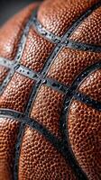 Close-up view of a wet basketball highlighting texture and grip details in an indoor setting photo