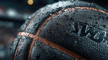 Close-up of a wet basketball resting on a court during an intense game at a sports arena in the evening photo