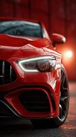 Bright red luxury car illuminated in dynamic lighting showcasing design details in a modern urban setting photo