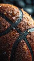 Close-up of a wet basketball with droplets showcasing its texture and design in a dramatic lighting setting photo