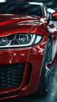 Red sports car with water droplets captured in a showroom setting during the afternoon photo
