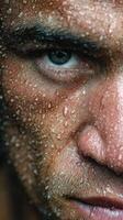 Intense close-up of a determined athlete with beads of sweat after a rigorous workout in the gym photo