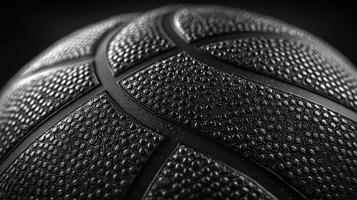 Close-up of a basketball highlighting its textured surface and droplets of moisture in a dramatic black and white setting photo