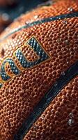 Close-up of a wet basketball with visible texture and droplets captured indoors just after a game photo