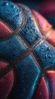 Close-up of a textured basketball with droplets highlighting its vibrant colors in a dramatic setting photo