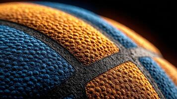 Close-up view of a vibrant basketball showcasing detailed texture and bright colors in a dramatic lighting setting photo