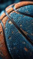 Basketball with textured surface in vibrant orange and blue colors focusing on detail and design elements photo