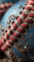 Weathered baseball with dirt and water droplets on a blue surface showcases field wear and tear during gameplay photo