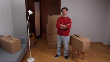 Man crossing arms looking confident after moving into new apartment video
