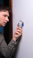 A man is holding a small object in his hand video