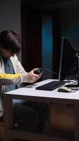 vertical angry male gamer after losing in computer game hits controller, joystick with hand video