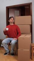 A man sitting on a chair with boxes around him video