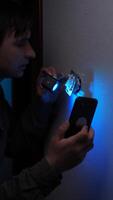 A man is using a flashlight to illuminate a cell phone video